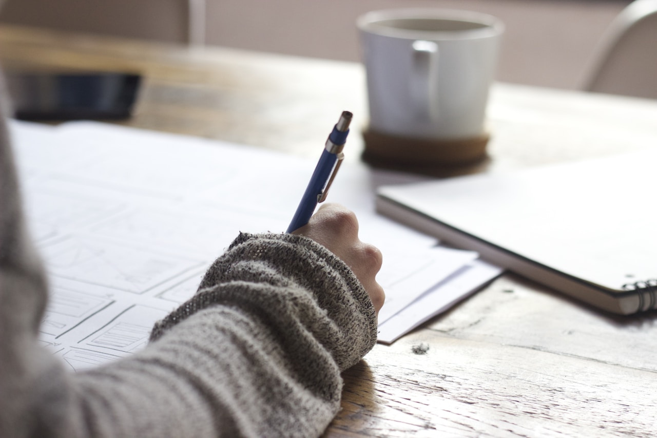 Person writing financial notes
